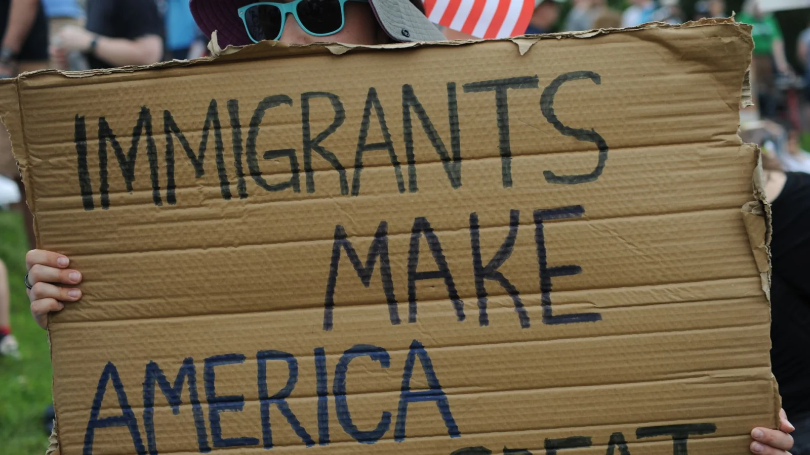 Close-up of sign reading 'Immigrants Make America Great' at a Baltimore rally.
